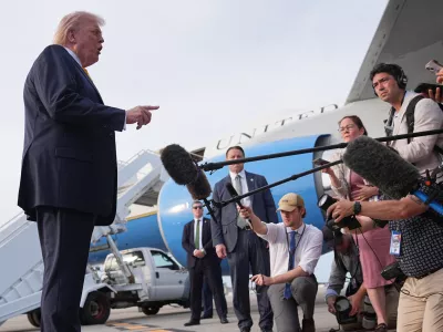 President Donald Trump talks to reporters before he boards Air Force One at Palm Beach International Airport in West Palm Beach, Fla., Saturday May 2, 2026, en route Miami. (AP Photo/Matt Rourke)