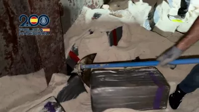 A police officer digs in the salt and uncovers bales of cocaine in a cargo vessel, in Tenerife, Canary Islands, Spain January 12, 2026 in this screengrab obtained from a video. Spanish Police/ via Reuters TV/Handout via REUTERS  THIS IMAGE HAS BEEN SUPPLIED BY A THIRD PARTY. MUST NOT OBSCURE LOGO.