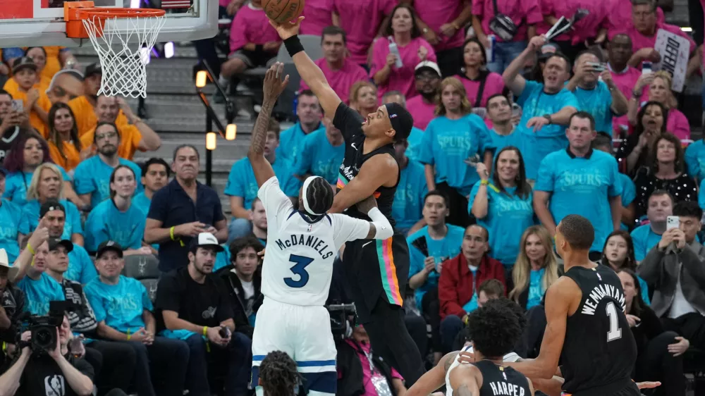 May 4, 2026; San Antonio, Texas, USA; San Antonio Spurs forward Keldon Johnson (3) shoots over Minnesota Timberwolves forward Jaden McDaniels (3) in the second half during game one of the second round of the 2026 NBA Playoffs at Frost Bank Center. Mandatory Credit: Daniel Dunn-Imagn Images