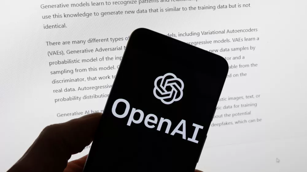 FILE - The OpenAI logo is displayed on a mobile phone in front of a computer screen with output from ChatGPT, March 21, 2023, in Boston. (AP Photo/Michael Dwyer, File)