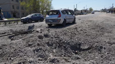 A crater is seen in a residential neighbourhood following a Russian missile attack in Merefa, Kharkiv region, Ukraine, Monday, May 4, 2026. (AP Photo/Andrii Marienko)