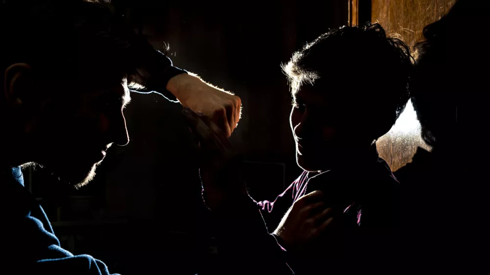 silhouette of two young guys in the dark place bully and fight concept