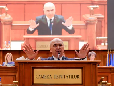 Romanian Prime Minister Ilie Bolojan addresses a parliament session ahead of a no confidence vote in Bucharest, Romania, Tuesday, May 5, 2026. (AP Photo/Vadim Ghirda)