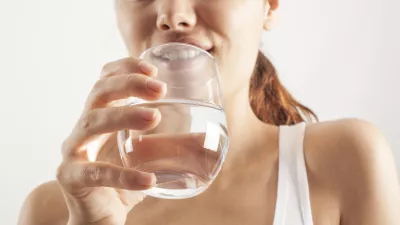Young woman drinking glass of water