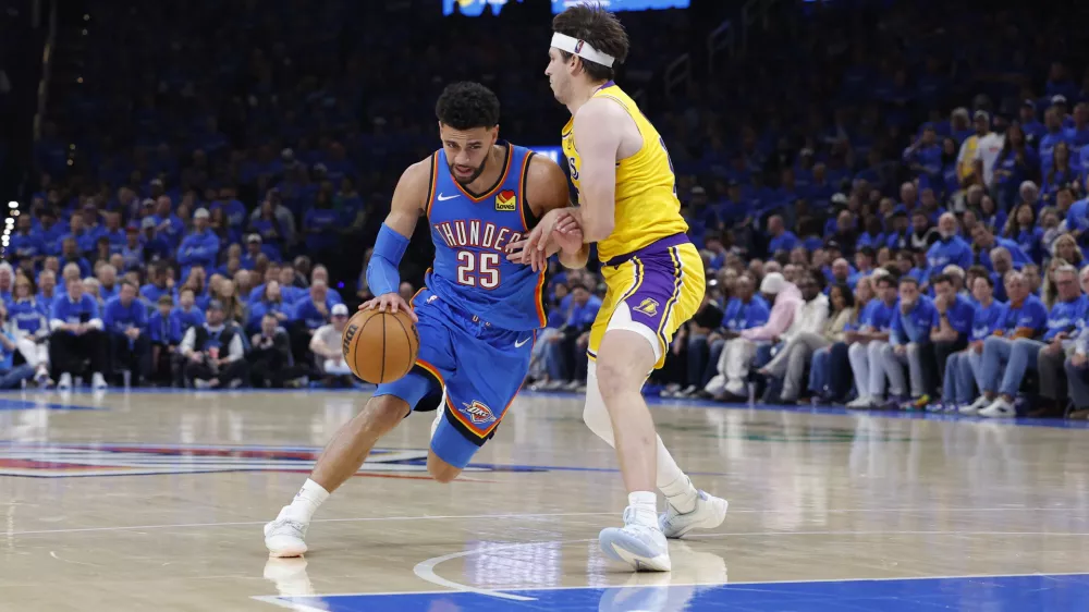 May 5, 2026; Oklahoma City, Oklahoma, USA; Oklahoma City Thunder guard Ajay Mitchell (25) dribbles around Los Angeles Lakers guard Austin Reaves (15) in the second half during game one of the second round of the 2026 NBA Playoffs at Paycom Center. Mandatory Credit: Alonzo Adams-Imagn Images