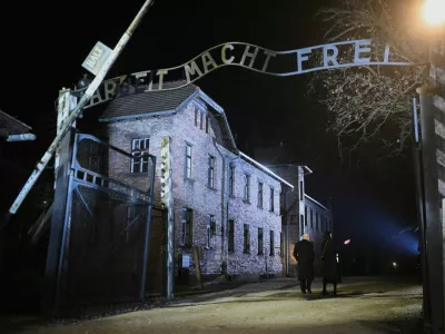 Britain's King Charles walks past the 'Arbeit Macht Frei' gate during a visit to Auschwitz, following commemorations to mark 80 years since the liberation of the Nazi German concentration and extermination camp, in Poland January 27, 2025. Victoria Jones/Pool via REUTERS