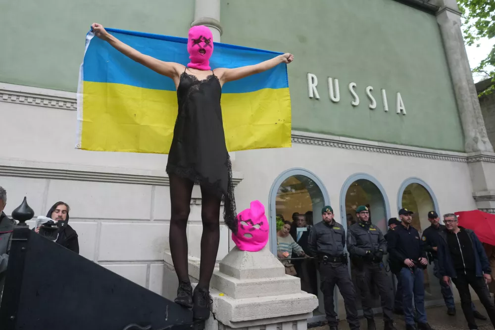 Pussy Riot and FEMEN activists stage a protest against Russia's presence after its absence following the 2022 invasion of Ukraine in front of the Russian pavilion, at the 2026 Art Venice Biennale, in Venice, Italy, Wednesday, May 6, 2026. (AP Photo/Luca Bruno)