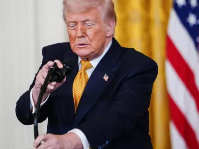President Donald Trump adjusts his microphone while speaking during an event for military mothers in the East Room of the White House, Wednesday, May 6, 2026, in Washington. (AP Photo/Julia Demaree Nikhinson)