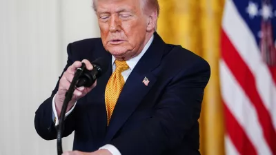 President Donald Trump adjusts his microphone while speaking during an event for military mothers in the East Room of the White House, Wednesday, May 6, 2026, in Washington. (AP Photo/Julia Demaree Nikhinson)