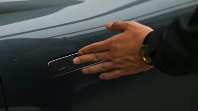 A man opens the door for a Zeekr X7 electric vehicle at a showroom in Beijing on February 3, 2026. China will ban hidden door handles on cars sold in the country from next year, phasing out the minimalist design popularised by Tesla over safety concerns.,Image: 1071617304, License: Rights-managed, Restrictions:, Model Release: no