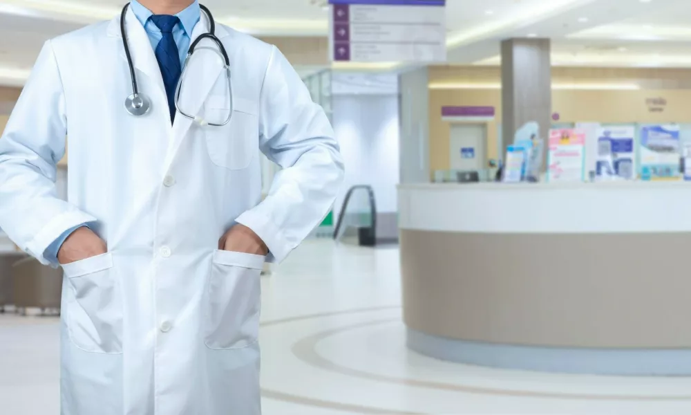 Smart doctor with a stethoscope around his neck on the hospital blurred background, Healthcare medical technology concept, copy space, Color effect tone, Copy space for text.,Image: 922087993, License: Royalty-free, Restrictions:, Model Release: yes