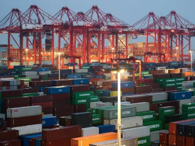 Gantry cranes stand near stacked shipping containers at Yangshan Port outside Shanghai, China, May 7, 2026. REUTERS/Go Nakamura