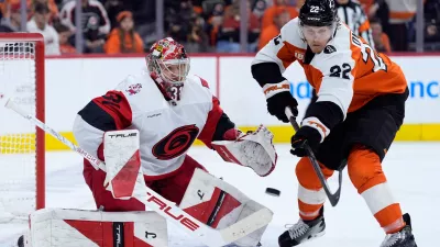 Carolina Hurricanes' Frederik Andersen, left, blocks a shot as Philadelphia Flyers' Christian Dvorak reaches in during the second period of Game 3 in the second round of the NHL hockey Stanley Cup playoffs, Thursday, May 7, 2026, in Philadelphia. (AP Photo/Matt Slocum)