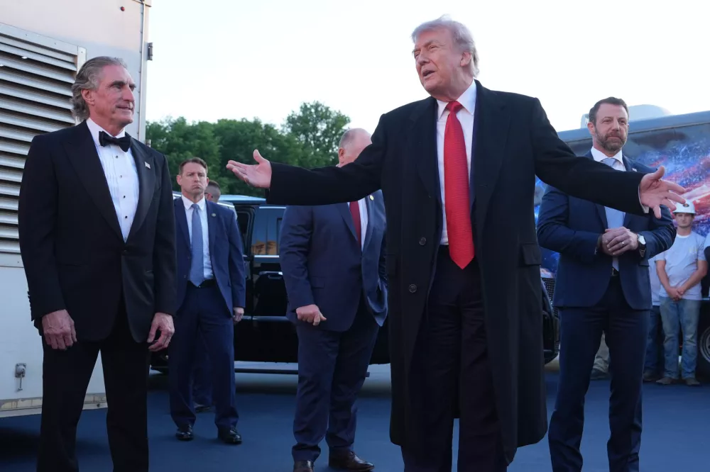 President Donald Trump speaks as he visits the Lincoln Memorial Reflecting Pool to see the new blue protective coating being applied as part of a renovation project, Thursday, May 7, 2026, in Washington, as Interior Secretary Doug Burgum and Homeland Security Secretary Markwayne Mullin listen. (AP Photo/Mark Schiefelbein)
