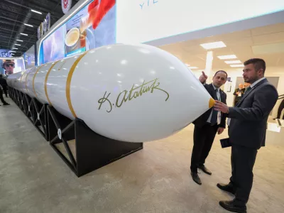 People stand next to a Turkish made intercontinental ballistic missile Yildirimhan on display at the SAHA International Defense and Aerospace exhibition in Istanbul, Turkey, Wednesday, May 6, 2026. (AP Photo)