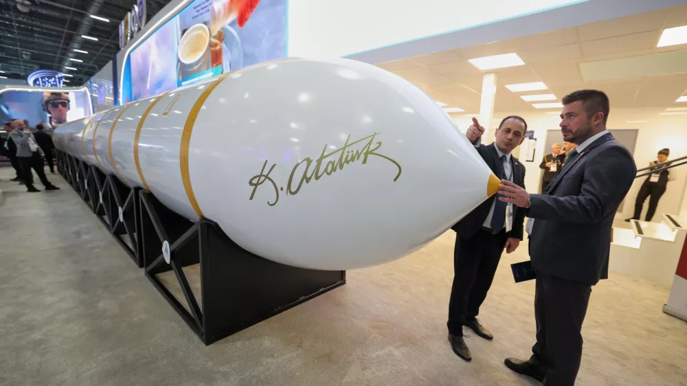People stand next to a Turkish made intercontinental ballistic missile Yildirimhan on display at the SAHA International Defense and Aerospace exhibition in Istanbul, Turkey, Wednesday, May 6, 2026. (AP Photo)