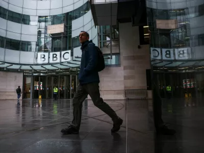 A person walks outside BBC Broadcasting House after Director General of BBC Tim Davie and Chief Executive of BBC News Deborah Turness resigned following accusations of bias at the British broadcaster, including in the way it edited a speech by U.S. President Donald Trump, in London, Britain, November 10, 2025. REUTERS/Jack Taylor
