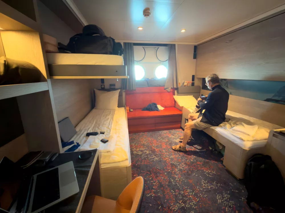 A passenger checks his camera inside his cabin on the hantavirus-stricken cruise ship, MV Hondius, during the voyage to Spain's port of Tenerife, May 6, 2026. (AP Photo)