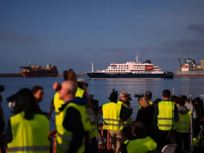 Media and emergency services personnel work next the hantavirus-stricken cruise ship MV Hondius after its arrival at the port of Granadilla in Tenerife, Canary Islands, Spain, Sunday, May 10, 2026. (AP Photo/Manu Fernandez)