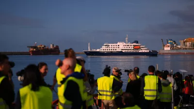 Media and emergency services personnel work next the hantavirus-stricken cruise ship MV Hondius after its arrival at the port of Granadilla in Tenerife, Canary Islands, Spain, Sunday, May 10, 2026. (AP Photo/Manu Fernandez)