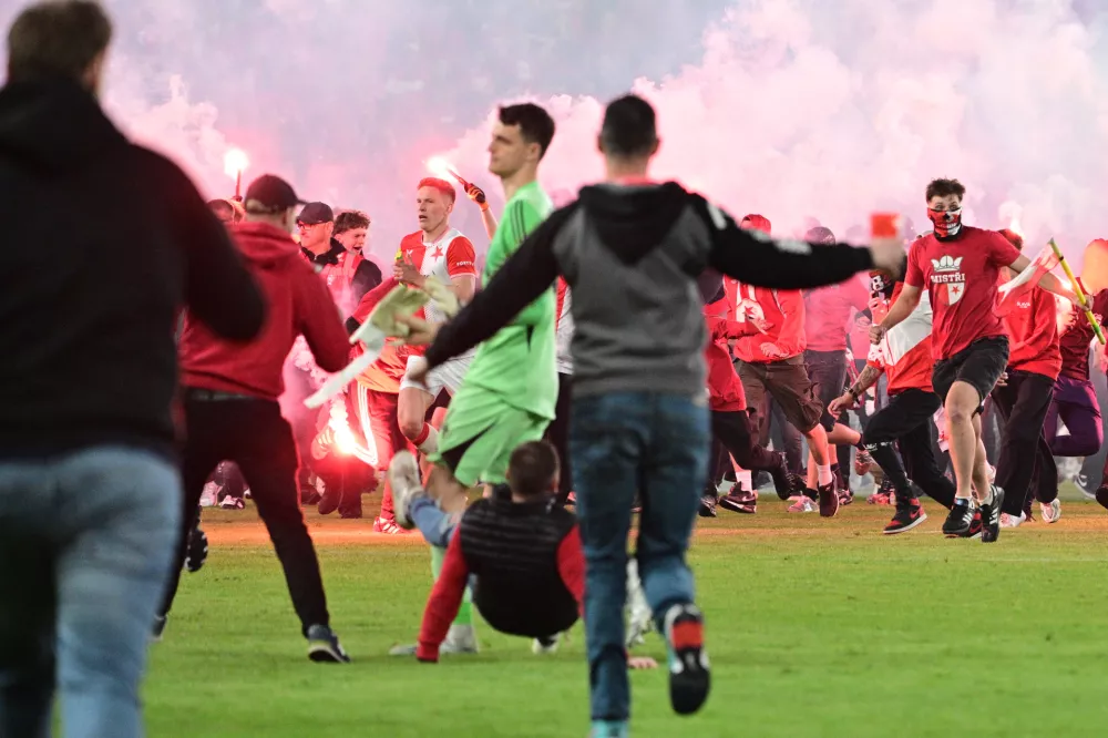 Fans get onto the pitch during the Czech league soccer derby match between Sparta Prague and Slavia Prague in Prague, Saturday, May 9, 2026. (Michal Kamaryt/CTK via AP)
