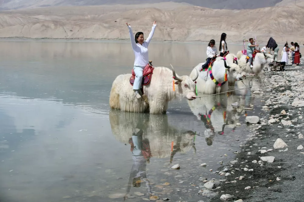 KIZILSU, CHINA - MAY 06: Tourists ride yaks at Baisha Lake scenic area on May 06, 2026 in Kizilsu Kyrgyz Autonomous Prefecture, Xinjiang Uygur Autonomous Region of China. Copyright: xVCGx 111640379758,Image: 1097823944, License: Rights-managed, Restrictions: imago is entitled to issue a simple usage license at the time of provision. Personality and trademark rights as well as copyright laws regarding art-works shown must be observed. Commercial use at your own risk.;PUBLICATIONxNOTxINxCHN, Model Release: no