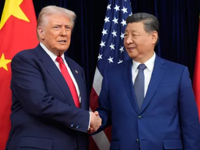 FILE - President Donald Trump, left, and Chinese President Xi Jinping shake hands before their meeting at Gimhae International Airport in Busan, South Korea, Oct. 30, 2025. (AP Photo/Mark Schiefelbein, File)