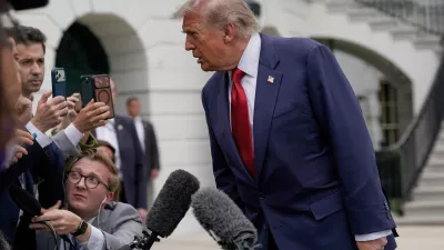 President Donald Trump speaks to reporters as he walks to board Marine One on the South Lawn of the White House, Friday, May 8, 2026, in Washington. (AP Photo/Jose Luis Magana)