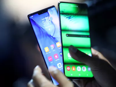 A person holds two new Huawei Mate 30 smartphones at the Convention Center in Munich, Germany September 19, 2019. REUTERS/Michael Dalder