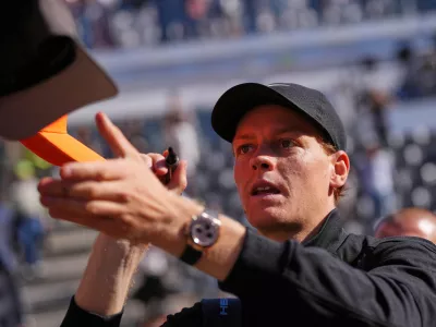 Italy's Jannik Sinner signs autographs after beating Australia's Alexei Popyrin 6-2, 6-0, after their match at the Italian Open tennis tournament in Rome, Monday, May 11, 2026. (AP Photo/Alessandra Tarantino)