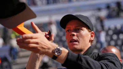 Italy's Jannik Sinner signs autographs after beating Australia's Alexei Popyrin 6-2, 6-0, after their match at the Italian Open tennis tournament in Rome, Monday, May 11, 2026. (AP Photo/Alessandra Tarantino)
