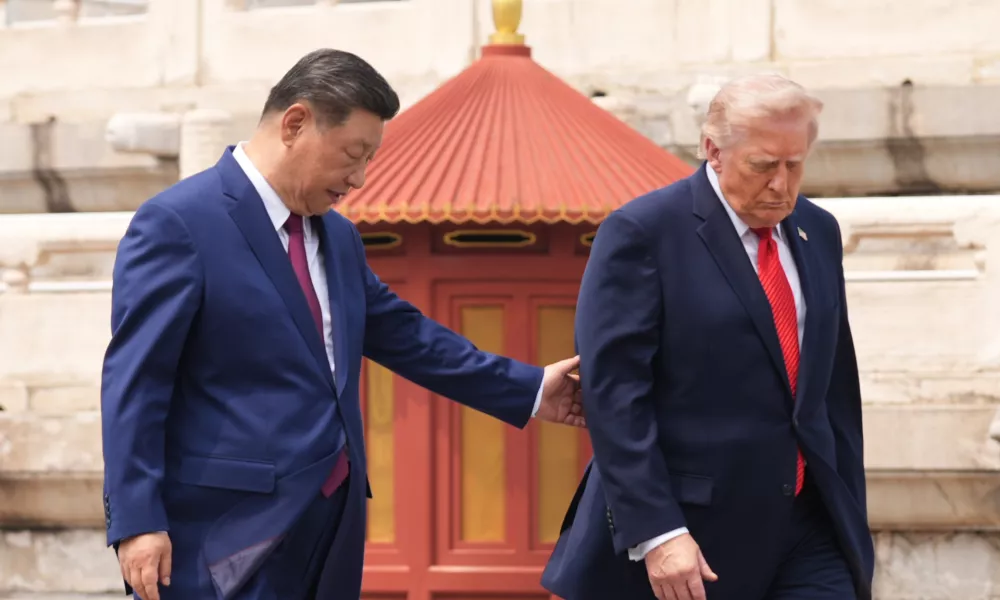 President Donald Trump, right, is assisted by Chinese President Xi Jinping at the Temple of Heaven on Thursday May 14, 2026, in Beijing. (AP Photo/Mark Schiefelbein)