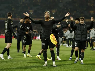 Soccer Football - Ligue 1 - RC Lens v Paris St Germain - Stade Bollaert-Delelis, Lens, France - May 13, 2026  Paris St Germain's Desire Doue and Paris St Germain's Joao Neves celebrate after winning Ligue 1 REUTERS/Benoit Tessier