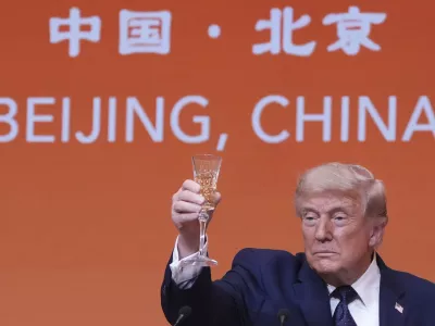President Donald Trump proposes a toast during a state dinner with China's President Xi Jinping at the Great Hall of the People on Thursday May 14, 2026, in Beijing. (AP Photo/Mark Schiefelbein)