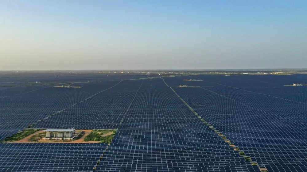 This photo taken on October 6, 2021 shows solar panels at the site of solar energy projects developer Saurya Urja Company of Rajasthan Limited, at the Bhadla Solar Park in Bhadla, in the northern Indian state of Rajasthan. Currently, coal powers 70 percent of the nation's electricity generation, but Indian Prime Minister Narendra Modi pledged on November 1 that it would produce more energy than India's entire grid now through solar and other renewables by 2030.,Image: 640990689, License: Rights-managed, Restrictions: TO GO WITH Climate-UN-COP26-energy-solar,FEATURE by Glenda KWEK, Model Release: no 