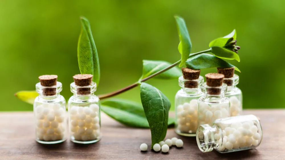 Classical Homeopathy globules in vintage bottles and nature leaves