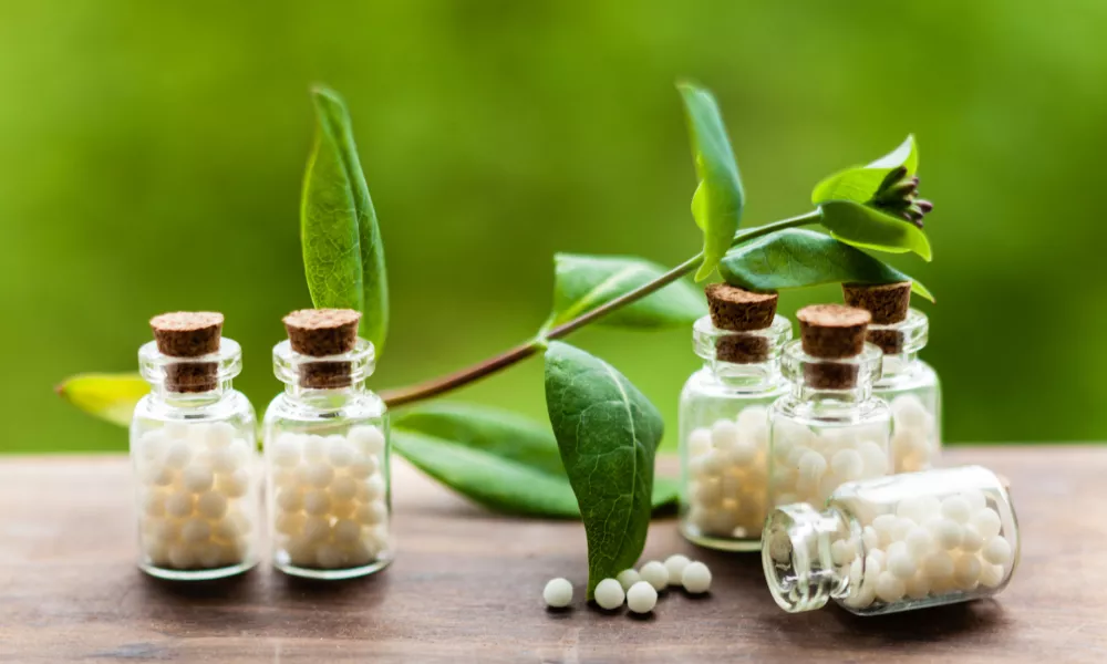 Classical Homeopathy globules in vintage bottles and nature leaves