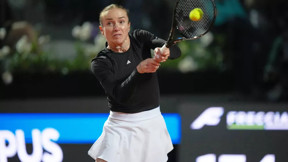 Ukraine's Elina Svitolina returns the ball to Poland's Iga Swiatek during their match at the Italian Open tennis tournament in Rome, Thursday, May 14, 2026. (AP Photo/Andrew Medichini)