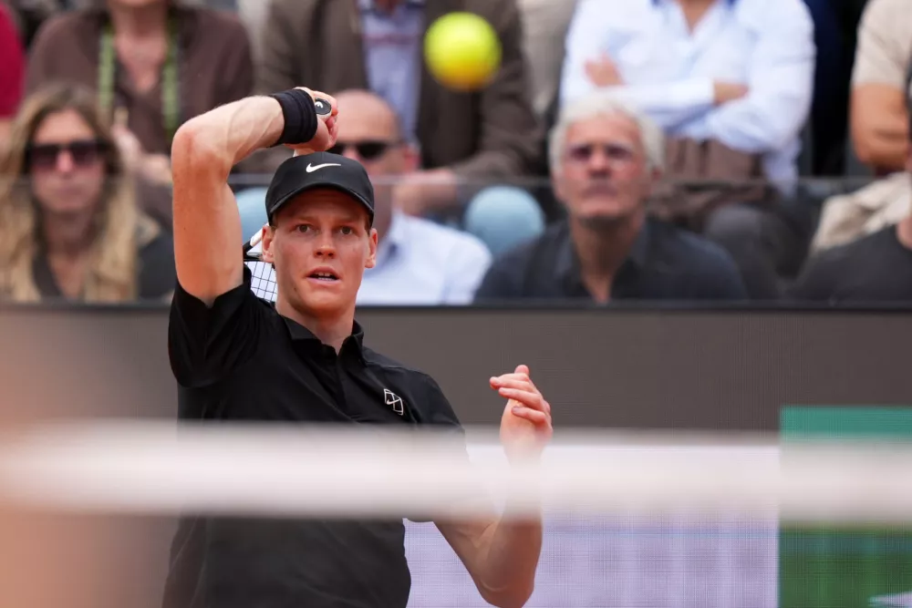 Italy's Jannik Sinner returns the ball to Andrey Rublev, during their match at the Italian Open tennis tournament in Rome, Thursday, May 14, 2026. (AP Photo/Andrew Medichini)
