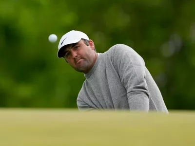 Scottie Scheffler chips onto the ninth green during the first round of the PGA Championship golf tournament at Aronimink Golf Club, Thursday, May 14, 2026, in Newtown Square, PA. (AP Photo/Carolyn Kaster)