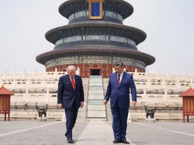 President Donald Trump, left, walks with Chinese President Xi Jinping at the Temple of Heaven on Thursday May 14, 2026, in Beijing. (AP Photo/Mark Schiefelbein)