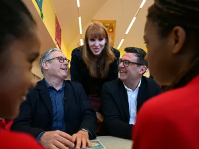 FILE - Britain's Prime Minister Keir Starmer, left, former deputy prime minister Angela Rayner and Manchester Mayor Andy Burnham meet with school children at a primary school in Ashton-under-Lyne, north-west England, Monday April 13, 2026. (Paul Ellis/Pool Photo via AP, File)