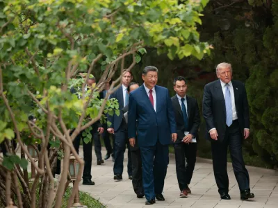 U.S. President Donald Trump, right, walks with Chinese President Xi Jinping while leaving after a visit to the Zhongnanhai Garden in Beijing, Friday, May 15, 2026. (Evan Vucci/Pool Photo via AP)