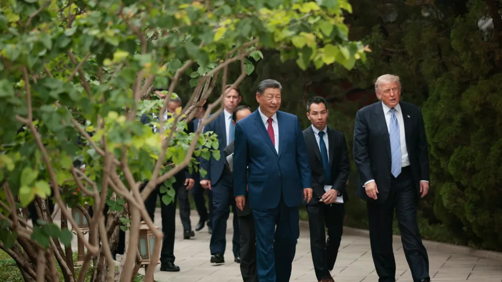 U.S. President Donald Trump, right, walks with Chinese President Xi Jinping while leaving after a visit to the Zhongnanhai Garden in Beijing, Friday, May 15, 2026. (Evan Vucci/Pool Photo via AP)