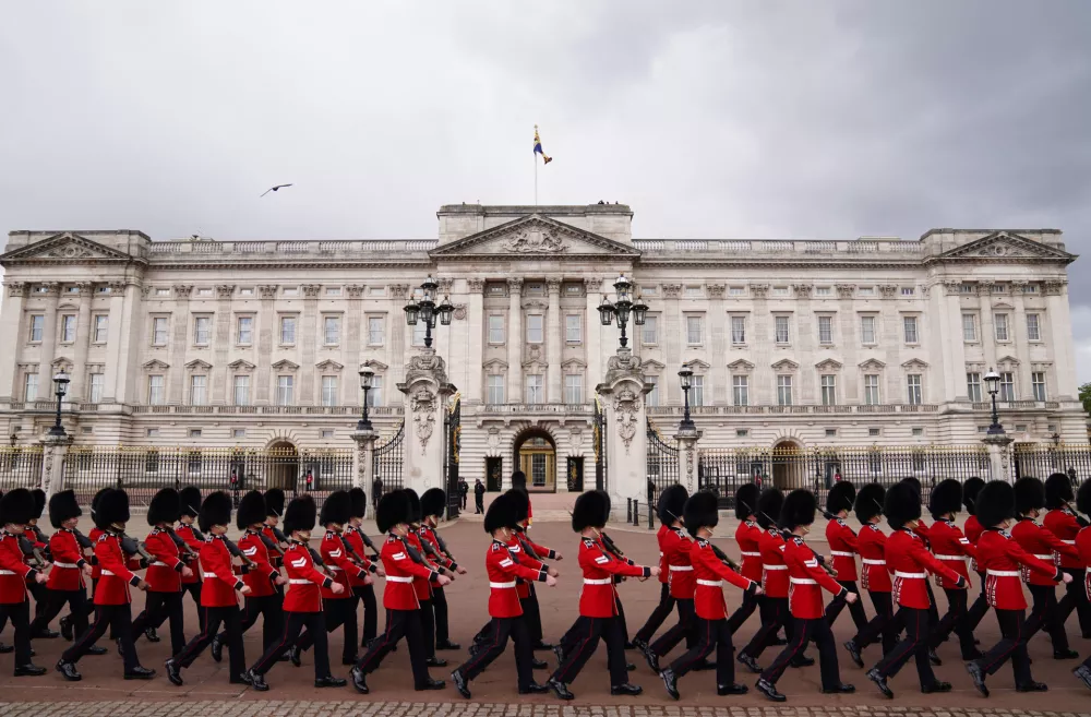 Members of the Household Division Foot Guards march outside Buckingham Palace, London, ahead of the state opening of Parliament, Wednesday May 13, 2026. (Ben Whitley/PA via AP)