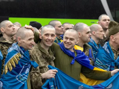 Ukrainian servicemen and former prisoners of war (POW) react after they set foot on Ukrainian soil after a POW swap with Russia, amid Russia's attack on Ukraine, at an undisclosed location in Ukraine May 15, 2026. REUTERS/Thomas Peter