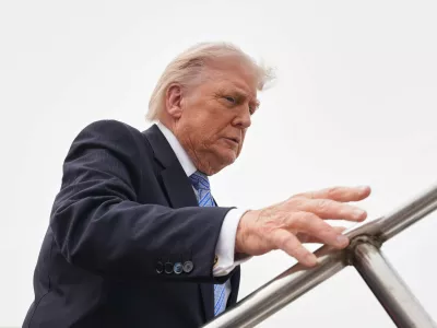 President Donald Trump boards Air Force One, Friday, May 15, 2026, at Beijing Capital International Airport in Beijing. (AP Photo/Mark Schiefelbein)