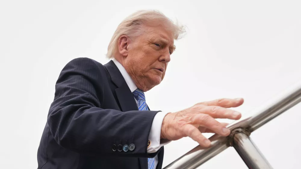 President Donald Trump boards Air Force One, Friday, May 15, 2026, at Beijing Capital International Airport in Beijing. (AP Photo/Mark Schiefelbein)
