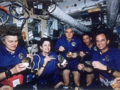 March 1996: NASA's STS-76 Atlantis Space Shuttle crew enjoying a meal aboard Russia's MIR Space Station. Their mission is part of the first phase of the International Space Program combining multinational efforts in a quest to establish a permanently-manned orbiting space laboratory. From left - mission specialists Shannon Lucid, Linda Godwin, and Michael Clifford, Pilot Richard Searfoss and commander Kevin Chilton. (Photo by Space Frontiers/Space Frontiers/Getty Images)