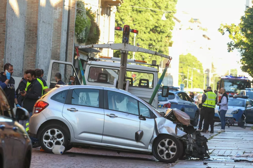 The car that drove into pedestrians is removed from the scene after several people were injured in the center of the northern Italian city of Modena, Italy, May 16, 2026. REUTERS/Stringer